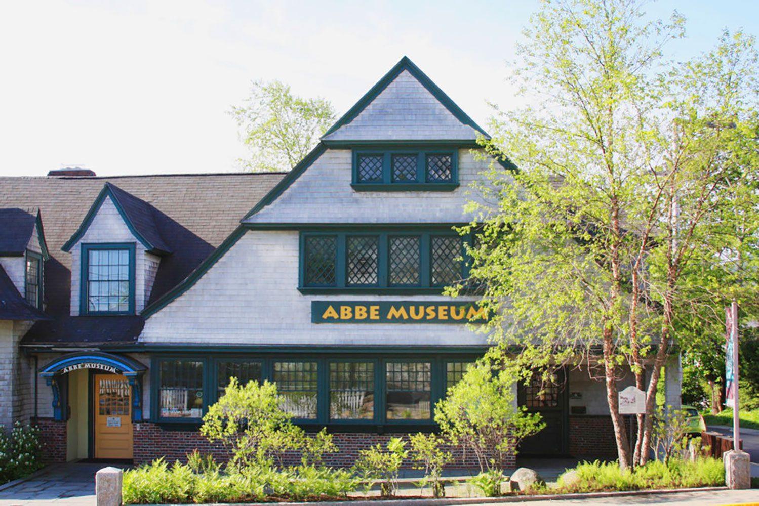 Abbe Museum's entrance surrounded by trees and gardens in the summer