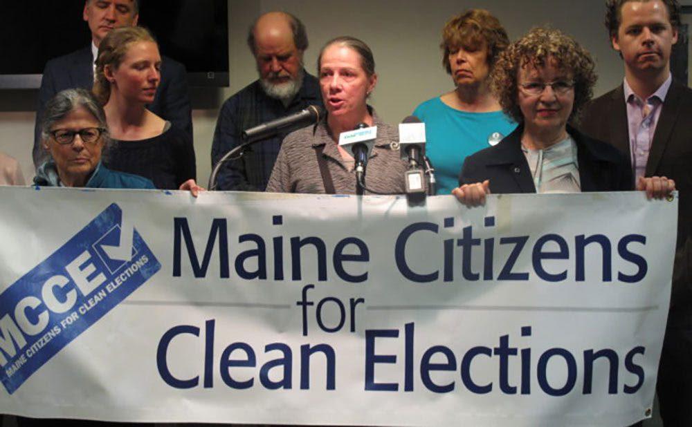 Women gather and hold a sign saying, Maine Citizens for Clean Elections