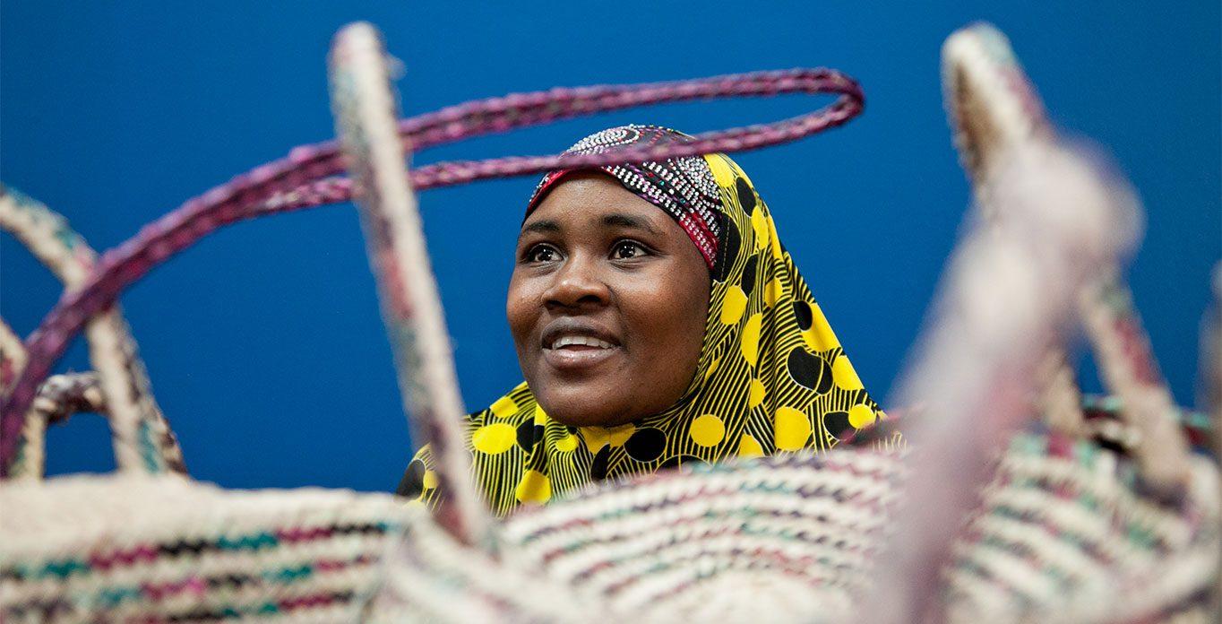 A woman smiles while wearing traditional garb.