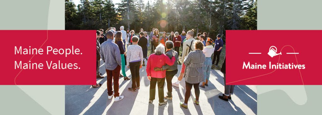 A gathering of people embrace in a circle