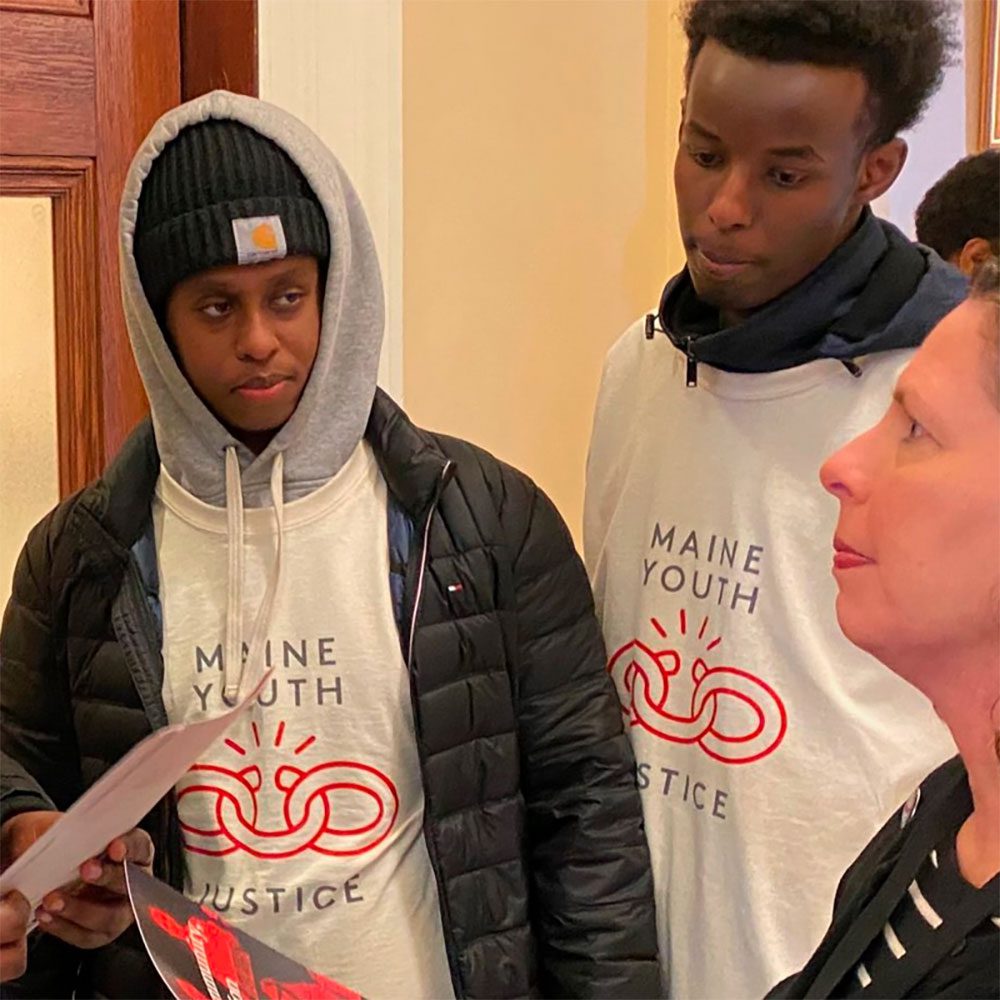 Young men gather together in the Maine Youth Justice program